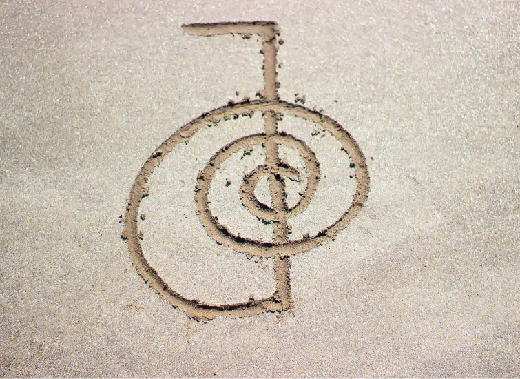 Reiki healing symbol cho ku rei on sand.